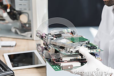 male technician hand wearing gloves holding computer parts. High quality photo Stock Photo