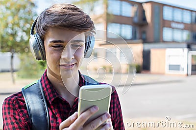 Male Teenage Student Outside College Building Streaming Music Fr Stock Photo