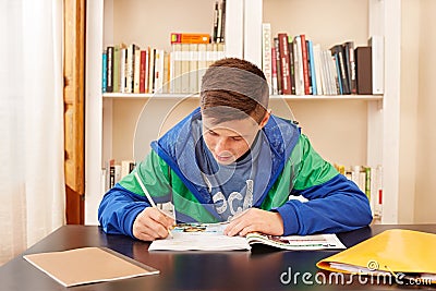 Male teenager concentrated doing homework Stock Photo