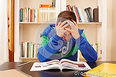 Male teenager worried doing homework Stock Photo