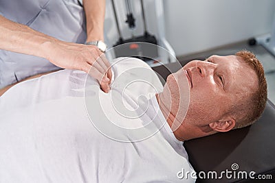 Male therapist massages table therapy for sport trauma patient close up Stock Photo