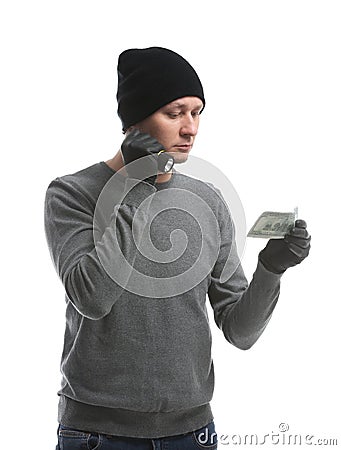 Male thief with flashlight and dollar banknote on white background Stock Photo