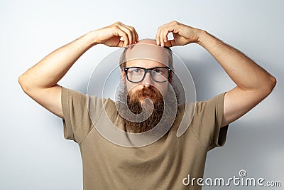 Male touching his head. problem with hair, suffering alopecia, needs trichologist consultation. Stock Photo