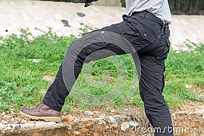 Male tourist wearing cargo pants standing in the park Stock Photo