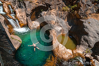 A male traveler bathes in a cold mountain river. To swim at Sapadere canyon and waterfall, Nature, Travel and vacation concept. Stock Photo