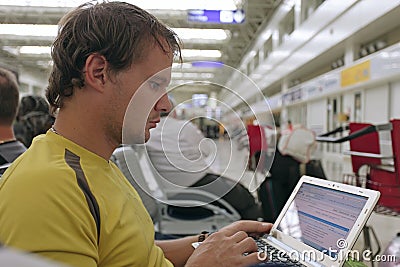 Male traveler working on his laptop computer Stock Photo