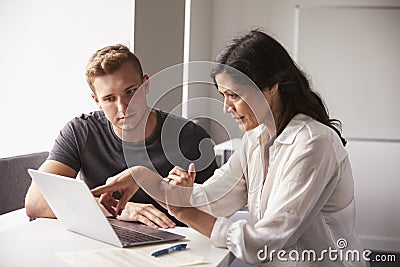 Male University Student Working One To One With Tutor Stock Photo