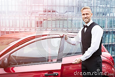 Male Valet Opening Car Door Stock Photo