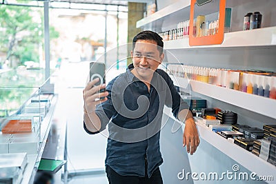 male vape seller taking selfie photo using the phone Stock Photo