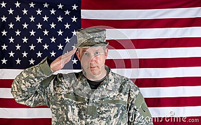 Male veteran solider saluting with USA flag in background Stock Photo