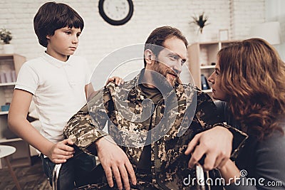 Male Veteran In Wheelchair Homecoming Concept. Stock Photo