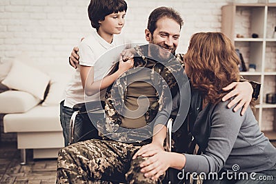 Male Veteran In Wheelchair Homecoming Concept. Stock Photo