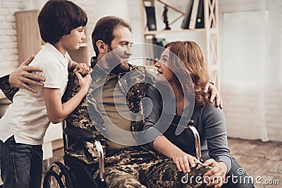 Male Veteran In Wheelchair Homecoming Concept. Stock Photo