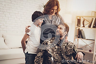 Male Veteran In Wheelchair Homecoming Concept. Stock Photo