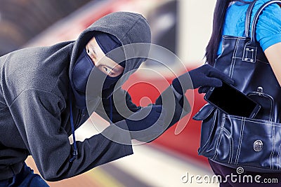 Male villain stealing smartphone from his victim Stock Photo