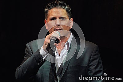 Male vocalist singing in a theatre show Editorial Stock Photo