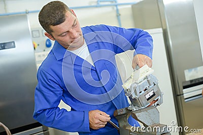 Male worker during appliance assembling work Stock Photo