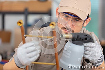 male worker building metal frame with welder Stock Photo