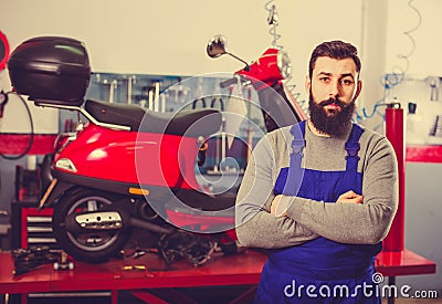 Male worker demonstrating motorbikes and scooters Stock Photo