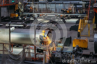 Male worker grinding butt weld pipe in metalwork workshop Editorial Stock Photo