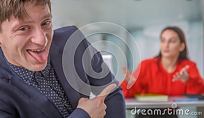 The male worker laughing and ignoring his female business boss. Latent aggression, competition, conflict concept. Horizontal Stock Photo