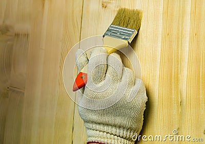 A male worker paints a surface with a brush Stock Photo