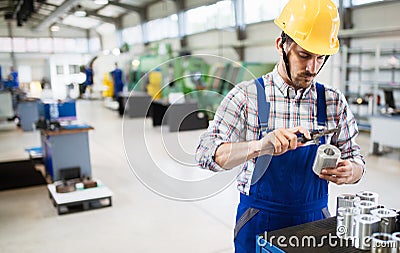 Male worker and quality control inspection in factory Stock Photo