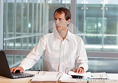 Male working with laptop in his office Stock Photo