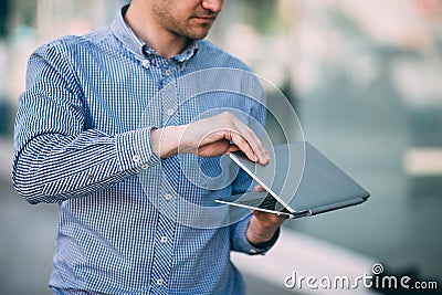 Male working on laptop on street Stock Photo