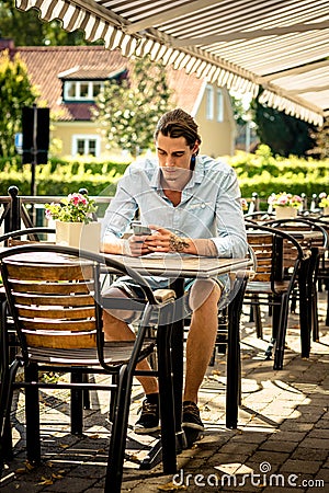 Male working on mobile phone Stock Photo