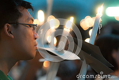 Male Worshiper with Lighted Candles Editorial Stock Photo