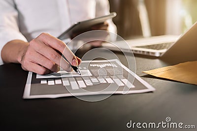 Male writes information businessman working on laptop computer and tablet. Stock Photo