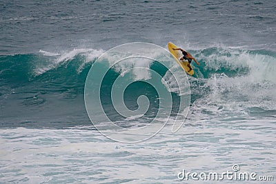 Yellow surfboard, turquoise waves Editorial Stock Photo