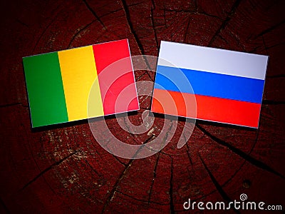 Malian flag with Russian flag on a tree stump Stock Photo