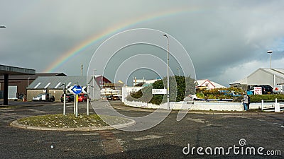 Mallaig, United Kingdom - 16 OCTOBER 2019 : View at roundabout in the town with rainbow in background. Editorial Stock Photo