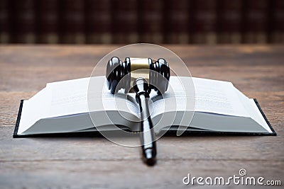 Mallet On Open Legal Book In Courtroom Stock Photo