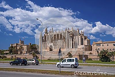 Cars moving on road by gothic La Seu Cathedral in city against sky Editorial Stock Photo