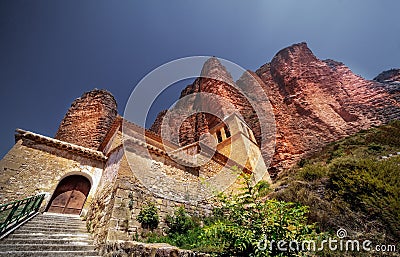 Mallos de Riglos rock formations near a concrete building in Huesca, Spain Stock Photo