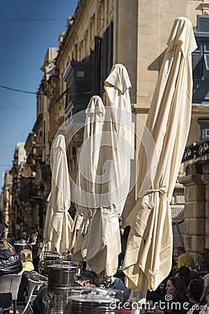 Furled sunshades on Republic Street Valletta Malta Editorial Stock Photo