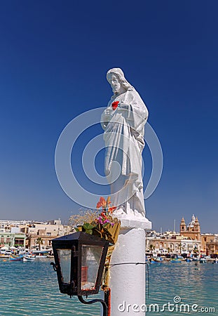 Malta. Saint guardian on the beach in the village of Marsaxlokk. Stock Photo