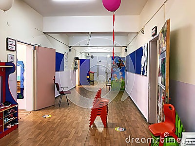 Corridor of an public kindergarten school and open doors and balloons around for educating students children schooling learning Editorial Stock Photo