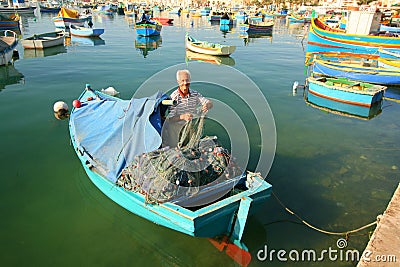 Fisherman in boat tending his nets Editorial Stock Photo