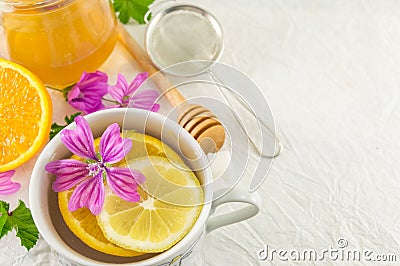 Malva sylvestris, mallow, tea with lemon and flowers Stock Photo