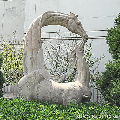 Mama & Baby Giraffe Statue Stock Photo