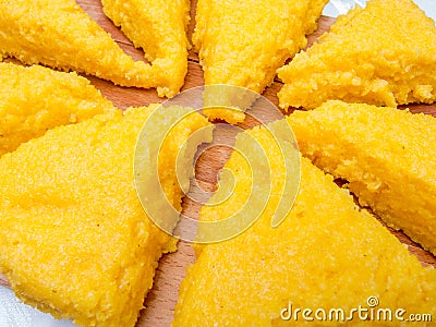 Mamaliga polenta triangles on wood Stock Photo