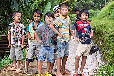 Mamasa, Indonesia - August 17, 2014: Group of unidentified funny children posing, smiling and looking at the camera in the country Editorial Stock Photo