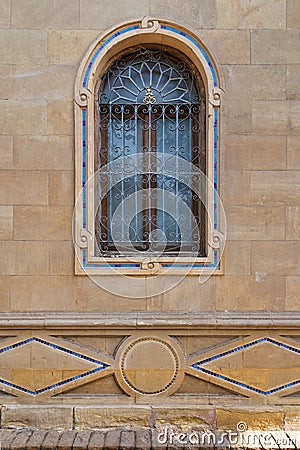 mamluk style arched Window with Wrought Iron Grilles in a brick wall Stock Photo