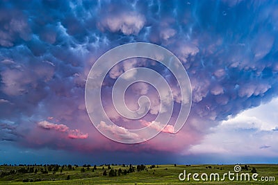 Mammatus clouds and stormy sky at sunset. Stock Photo