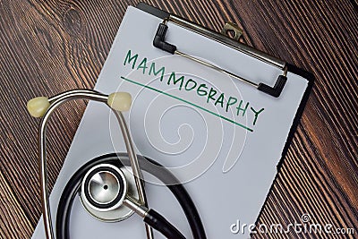 Mammography write on a paperwork isolated on Wooden Table. medical concept Stock Photo