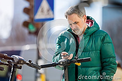 Man activating electric scooter from smartphone Stock Photo